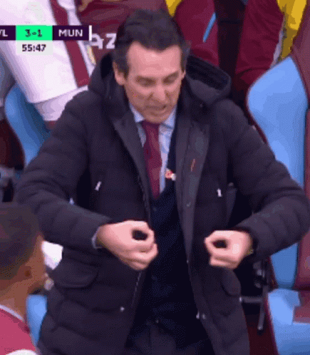 Man in Suit Watching Soccer Game