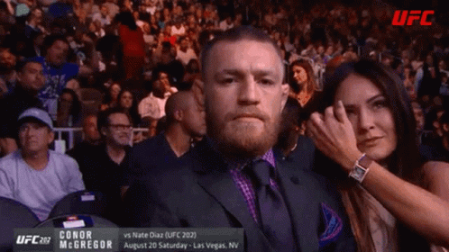 Man in Suit Watching UFC Fight