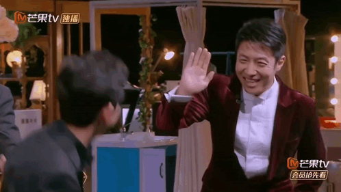 Man in Suit Waving at Another Man MTV