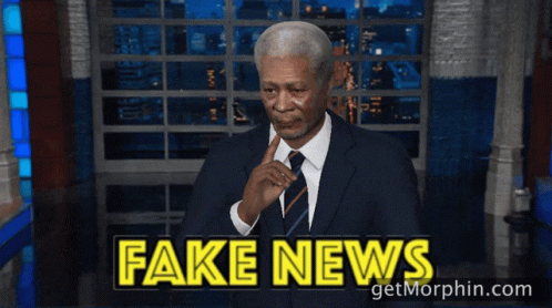 Man in Suit Waving at Fake News
