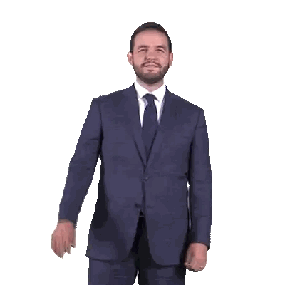 Man in Suit Waving in Front of Fox Deportes