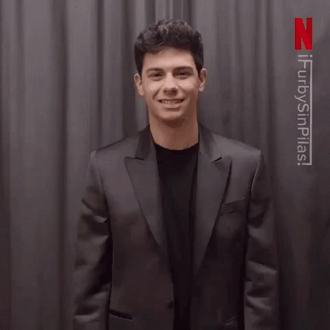Man in Suit Waving Saying Gracias