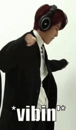 Man in Suit Wearing Headphones Vibin