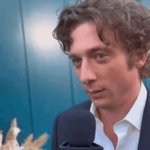 Man In Suit White Shirt Talking Into Microphone GIF