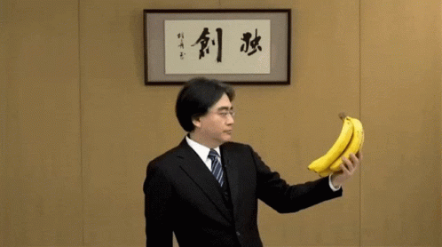 Man in Suit With Banana and Chinese Writing