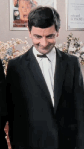 Man In Suit With Bow Tie Smiling GIF