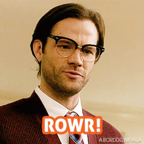 Man in Suit With Glasses Saying Rowr