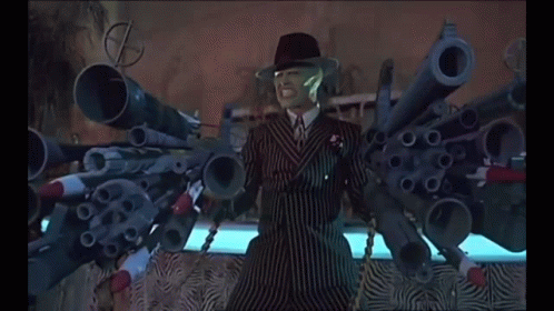 Man in Suit With Guns Saying Bang