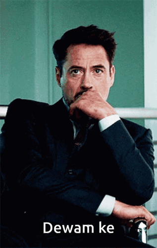 Man in Suit with Hand on Chin Dewam Ke