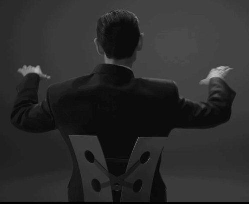 Man in Suit With Letter V on Back