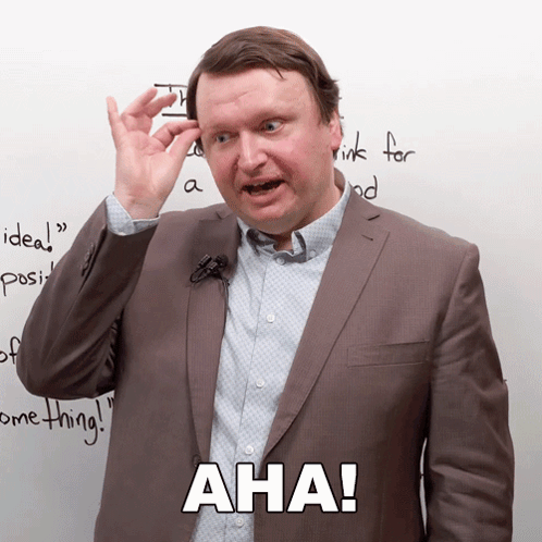 Man in Suit with Microphone Says Aha
