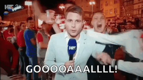 Man in Suit with Microphone Yells Goooooaaalll