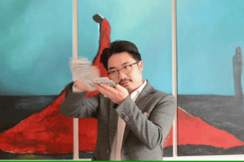 Man in Suit With Money Next to Red Dress Painting