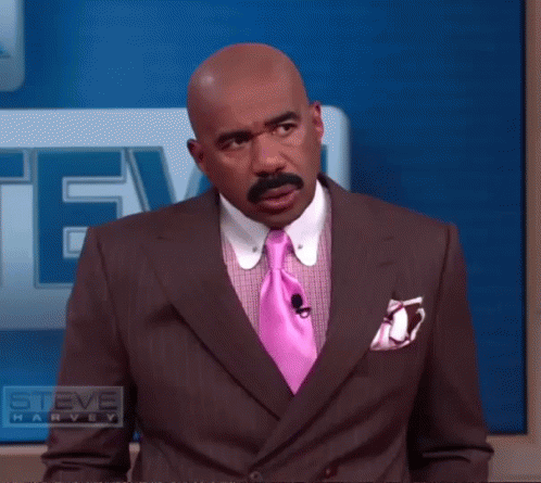 Man In Suit With Pink Tie And Steve Harvey Logo GIF
