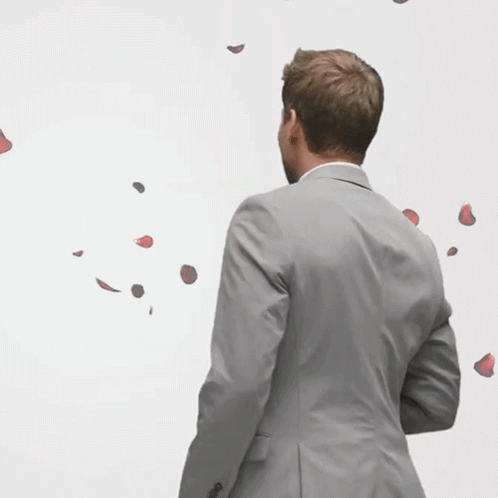 Man In Suit With Rose Petals GIF