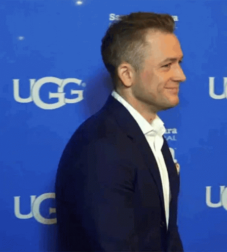 Man In Suit With UGG On Blue Background GIF