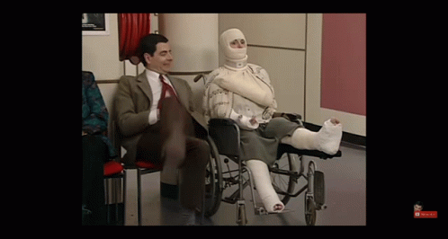 Man In Suit Woman In Wheelchair With Cast GIF