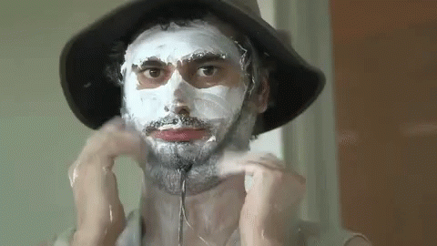 Man In Sun Hat With Lotion In Face GIF