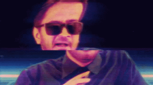 Man in Sunglasses and Black Shirt on Screen
