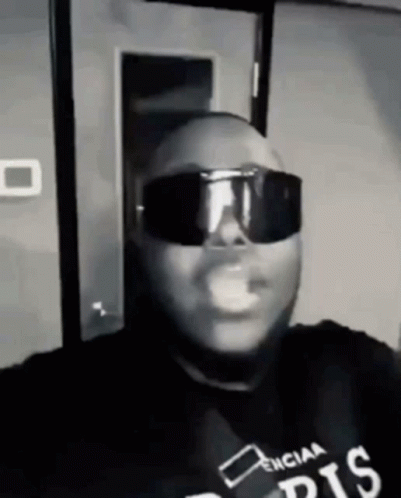 Man in Sunglasses and Black Shirt Smoking Black and White