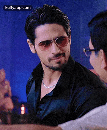 Man in Sunglasses and Black Shirt Talking