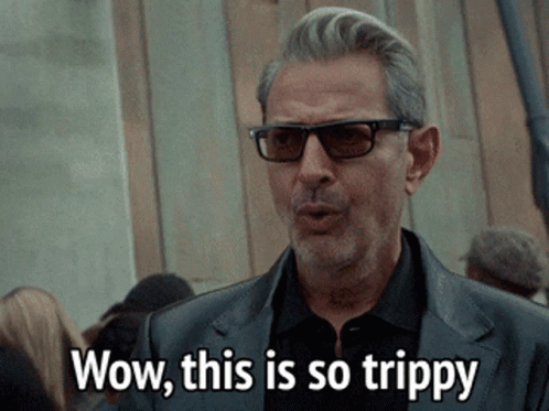 Man In Sunglasses And Black Suit Saying Wow This Is So Trippy GIF