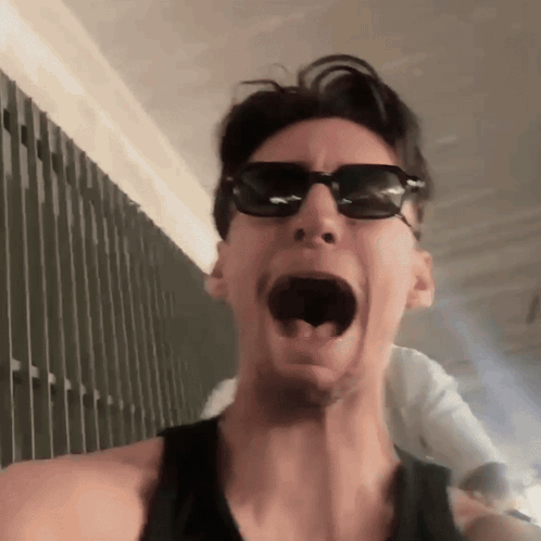 Man in Sunglasses and Black Tank Top Making Funny Face
