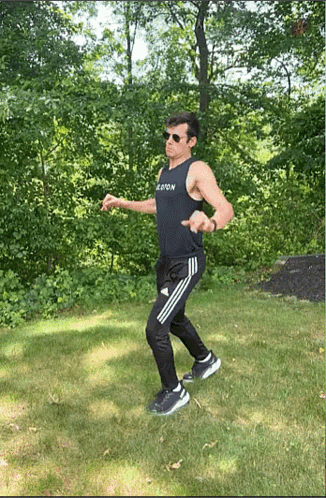 Man in Sunglasses and Black Tank Top Saying Boston