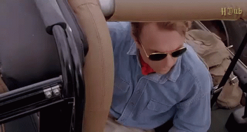 Man In Sunglasses And Blue Shirt Sitting In Back Seat Of Car GIF