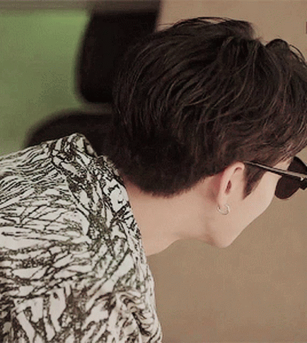 Man in Sunglasses and Earrings Looking Down