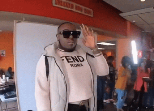 Man in Sunglasses and Fendi Roma Shirt Waving Hand