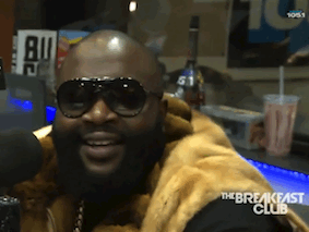Man In Sunglasses And Fur Coat Smiling At Breakfast Club Microphone GIF