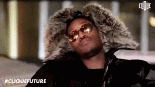 Man in Sunglasses and Fur Hood Looking at Camera
