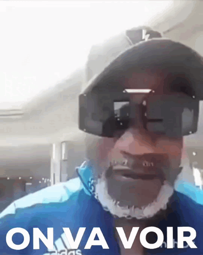 Man In Sunglasses And Hat Saying On Va Voir GIF