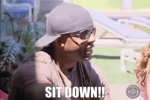 Man in Sunglasses and Hat Says Sit Down