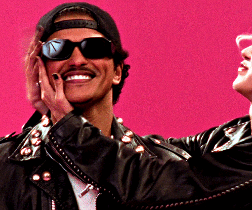 Man in Sunglasses and Hat Smiling Covering Face