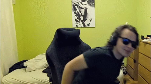Man In Sunglasses And Headphones Sitting In Bedroom GIF