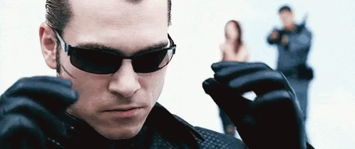 Man In Sunglasses And Leather Gloves Standing In Front Of Woman GIF