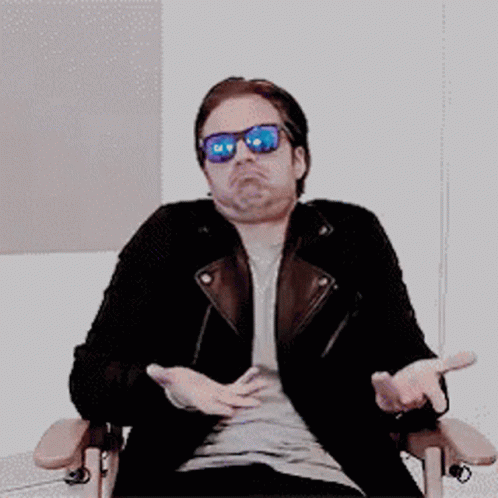 Man in Sunglasses and Leather Jacket Arms Outstretched