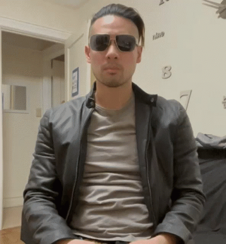 Man In Sunglasses And Leather Jacket With Clock Nine GIF