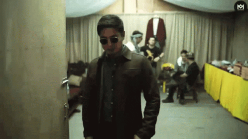 Man in Sunglasses and Leather Jacket with Letter M