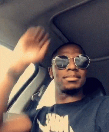 Man in Sunglasses and Nike Shirt Waving