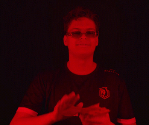 Man in Sunglasses and Orans Applauds Shirt