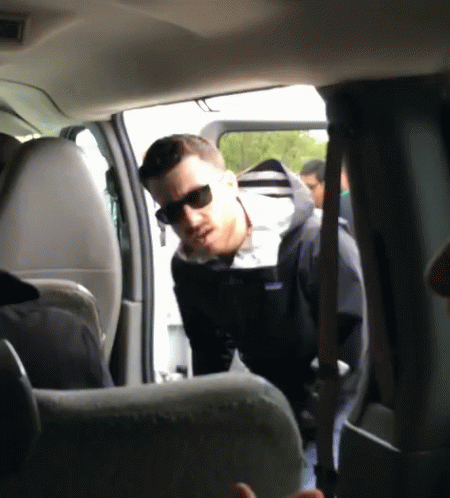 Man in Sunglasses and Patagonia Jacket Standing in Car