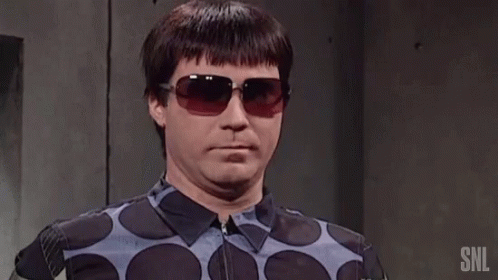 Man in Sunglasses and Polka Dot Shirt With SNL Text