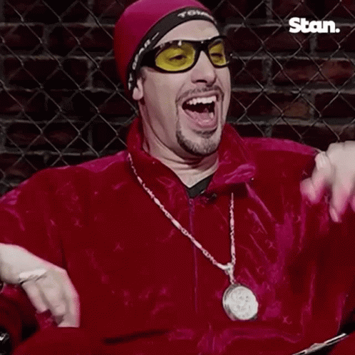Man in Sunglasses and Red Jacket Saying Wicked