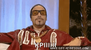 Man in Sunglasses and Red Jacket Sitting on Couch Making Funny Face