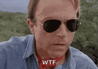 Man In Sunglasses And Red Scarf Saying WTF GIF