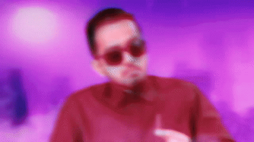 Man in Sunglasses and Red Shirt on Purple Background