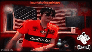 Man in Sunglasses and Red Shirt Saying Hauntholics Mixtape Dancing in Front of American Flag
